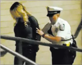  ??  ?? The Associated Press In this frame from video, Stormy Daniels is led into jail Wednesday in Columbus, Ohio, after being taken into custody during a show at a strip club.