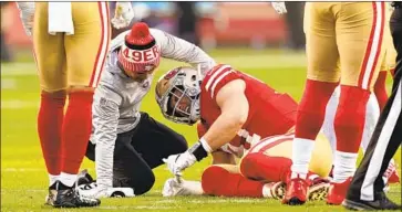  ?? Thearon W. Henderson Getty Images ?? NICK BOSA had the wind knocked out of him as he made his second sack against Kirk Cousins on Saturday.