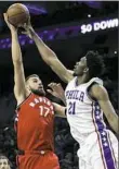  ?? Matt Slocum/Associated Press ?? Joel Embild blocks the shot of Toronto Raptors' Jonas Valanciuna­s in the the first half of Philadelph­ia’s victory Wednesday night.