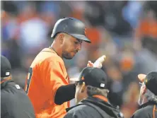  ?? Lachlan Cunningham / Getty Images ?? Giants coaches greet Chris Marrero after his two-run home run in the second inning, the first of his major-league career.