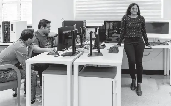 ?? Sam Owens/Staff photograph­er ?? Doctoral students Vedant Karia, left, and Tej Pandit work at the Neuromorph­ic AI Lab at UTSA with Dr. Dhireesha Kudithipud­i, who runs the research program.