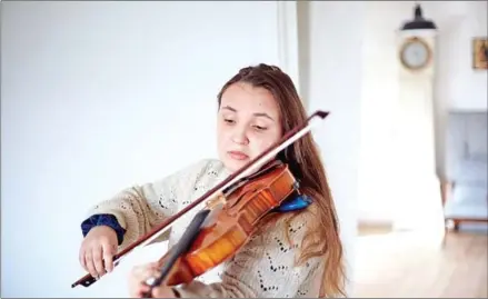 ?? AFP ?? Nadia Safina, a 24-year-old musician from Kharkiv in Ukraine, plays her instrument in Stevns, Denmark, on March 10.