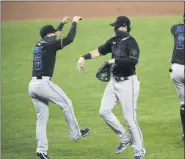  ?? NICK WASS - FREELANCER, AP ?? Miami Marlins’ Brian Anderson, center, Eddy Alvarez, left, and Jonathan Villar (2) celebrate after a baseball game against the Baltimore Orioles, Thursday, Aug. 6, 2020, in Baltimore.