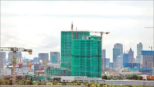  ?? HONG MENEA ?? ‘High-rise buildings’ – a designatio­n for those at least five storeys tall – in Phnom Penh in August.