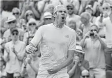  ?? Ben Curtis / Associated Press ?? Reilly Opelka loves that winning feeling after outlasting Stan Wawrinka in a five-set match Wednesday at Wimbledon.