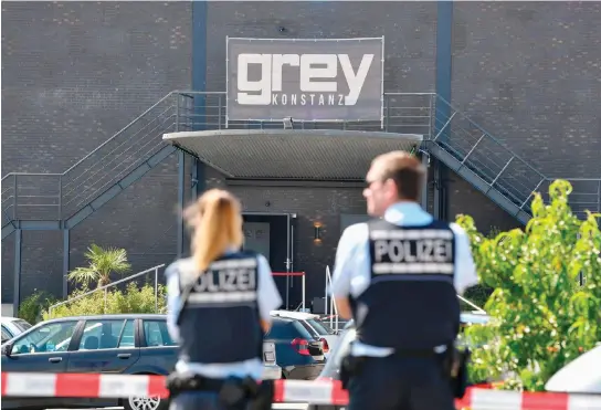  ??  ?? Police stand in front of the Grey nightclub in Konstanz, southern Germany, where a gunman opened fire, killing one and wounding four people before being shot by police, on Sunday. (AFP)