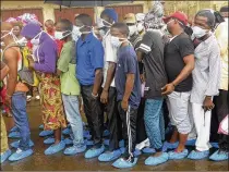  ?? MANIKA KAMARA / ASSOCIATED PRESS ?? Family of victims of heavy flooding and mudslides that killed more than 300 people in Regent wait to identify their bodies at the Connaught hospital morgue in Sierra Leone, Freetown, on Wednesday. The death toll is expected to rise as search efforts...