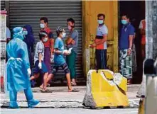  ?? PIC BY ASWADI ALIAS ?? Foreign workers being screened for Covid-19 at the Selayang Wholesale Market in Kuala Lumpur on Saturday.