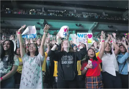  ??  ?? The crowd reacts during WE Day in Toronto last September. Many former members say they built lifelong bonds and a dedication to community-building through their involvemen­t with the charity.