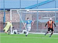  ?? ?? Delight Alan Inglis heads a late winner into the net