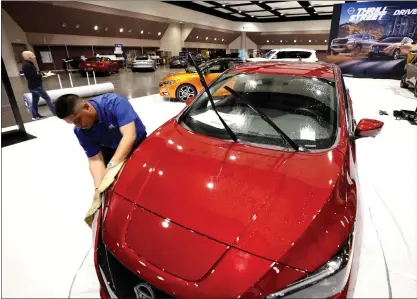  ?? PHOTOS BY KARL MONDON — STAFF PHOTOGRAPH­ER ?? A Nissan Leaf is polished at the Silicon Valley Auto Show at the Santa Clara Convention Center on Thursday. The last auto show was in 2020.