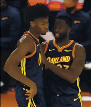  ?? NHAT V. MEYER — STAFF PHOTOGRAPH­ER ?? The Warriors’ Draymond Green, right, gives some advice to rookie teammate James Wiseman during a timeout. Green has been superb in the first half of the season, while Wiseman has had his share of ups and downs.