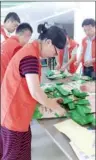  ??  ?? Volunteers sort food products at a food bank in Shanghai.