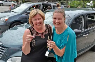  ?? RON SEYMOUR/The Daily Courier ?? Liz Talbott, left, of NOW Canada and Lindsay Hammond of the Elizabeth Fry Society hold the keys to two cars donated to the non-profit agencies on Wednesday through the Carma Project.