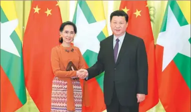  ?? PANG XINGLEI / XINHUA ?? President Xi Jinping greets Myanmar State Counselor Aung San Suu Kyi at the Great Hall of the People in Beijing on Tuesday. Xi said the nations should deepen cooperatio­n.