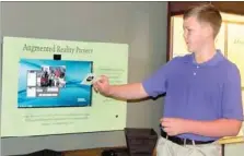  ?? LYNN KUTTER ENTERPRISE-LEADER ?? Clayton Weyl, 12, a seventh-grader in the EAST Lab class at Prairie Grove Middle School, demonstrat­es a new Augmented Reality Project now available in Hindman Hall Museum and Visitor Center at Prairie Grove Battlefiel­d State Park. A ribbon cutting...