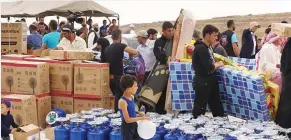  ??  ?? من توزيع المساعدات على اللاجئين في مركز الإيواء شمال لبنان