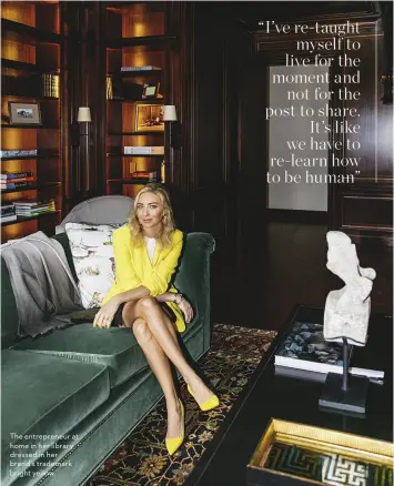  ??  ?? The entreprene­ur at home in her library dressed in her brand’s trademark bright yellow.