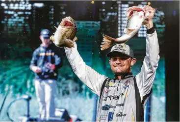  ?? Brett Coomer photos / Houston Chronicle ?? Bassmaster­s Classic winner Jordan Lee holds up two of the five fish he caught Sunday at Lake Conroe — a stringer that weighed in at 27 pounds, 4 ounces and lifted him to a 1-pound, 9-ounce win over Steve Kennedy.
