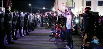  ?? — AFP photo ?? Protesters face off with police outside the County Courthouse during demonstrat­ions against the shooting of Jacob Blake in Kenosha, Wisconsin.