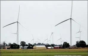  ?? AP/SUE OGROCKI ?? A house and outbuildin­gs are surrounded by wind turbines in Calumet, Okla. A decade ago, states welcomed developers, envisionin­g a bright future for the industry. Today, many of the same political leaders who welcomed the wind industry want to regulate...