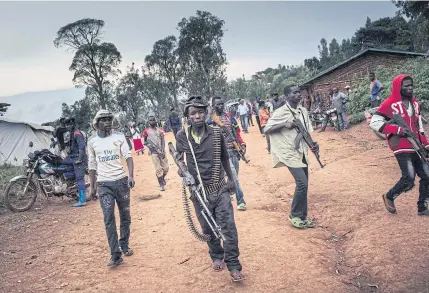  ?? AFP ?? Codeco militiamen stand guard during a meeting with former warlords in the village of Wadda, Ituri in northeaste­rn Democratic Republic of Congo in 2020.