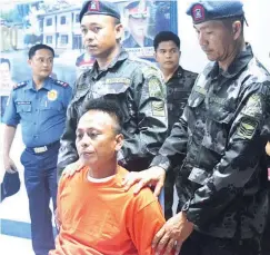  ??  ?? 6 MURDERS — Jessie Tesoro, 34, suspected of killing his live-in partner and five other members of their household while under the influence of liquor in San Leonardo, Nueva Ecija, is presented to media yesterday after his arrest in Tarlac City. (Ariel...