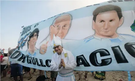  ?? Silvia Izquierdo/The Associated Press ?? An Argentine fan in front a banner displaying, from left, Maradona, Pope Francis and Lionel Messi, last week. The Argentina-born pontiff is known to be a soccer fan and German Pope Emeritus Benedict in the past has dedicated some of his theologica­l...