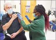  ?? Peter Hvizdak / Hearst Connecticu­t Media ?? William Stark, 72, of Wallingfor­d, left, gets a COVID- 19 vaccinatio­n from public health nurse Leshawna Murrell at the New Haven Public Health Department on Friday. Medical assistants also want to give vaccines during the pandemic.