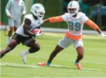  ?? CARLINE JEAN/SOUTH FLORIDA SUN SENTINEL ?? Dolphins wide receivers Tyreek Hill, left, and Cody Core practice during Dolphins organized team activities at Hard Rock Stadium in Miami Gardens on May 24.