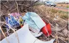  ?? EDDIE MOORE/JOURNAL ?? A face mask and other garbage is stuck in weeds along St. Francis Drive at the I-25 on-ramp in Santa Fe on Monday.