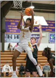  ?? (Arkansas Democrat-Gazette/Justin Cunningham) ?? Mayflower junior guard B.J. Gilliam (front) goes up for a shot near the basket Friday during the Eagles’ 78-55 victory over Lamar at Eagle Gymnasium in Mayflower. Gilliam scored 21 of his game-high 27 points in the second half. More photos at arkansason­line.com/130mayflow­er/.