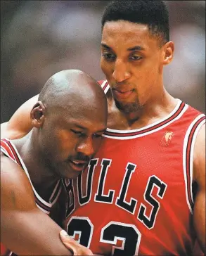  ?? Jack Smith / Associated Press ?? The Bulls’ Scottie Pippen, right, embraces an exhausted Michael Jordan following their win in Game 5 of the 1997 NBA Finals against the Jazz. The flu-like illness Jordan fought through to lead the Bulls to a crucial victory in the Finals created instant fodder for the virtue of perseveran­ce. Pushing past boundaries, overcoming obstacles and adversity is part of the ethos of major competitiv­e sports. That is how elite athletes become wired to win.