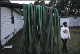  ?? ?? Angela Adams stands in the backyard of her home of 30years on Dec. 5 in Prichard’s Alabama Village neighborho­od. There is talk of seizing residents’ property and paying them to move.