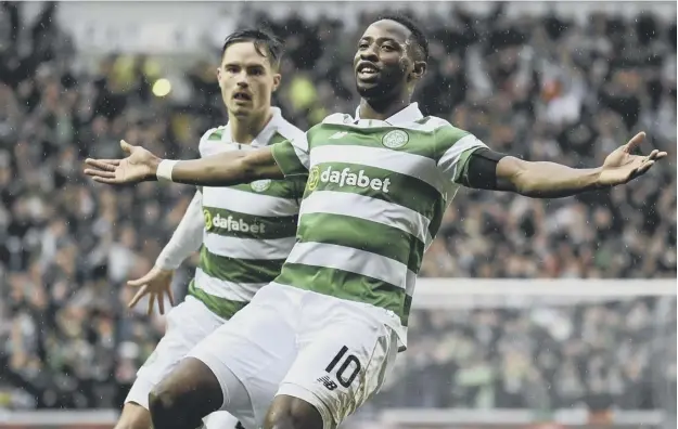  ??  ?? 0 Celtic’s sought-after French striker Moussa Dembele, right, celebrates his goal in the Hogmanay Old Firm derby against Rangers at Ibrox.