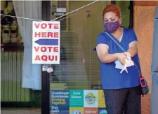  ??  ?? Guadalupe Councilwom­an Anita Cota-Soto, running for reelection, washes up before voting at El Tianguis Mercado. MARK HENLE/THE REPUBLIC