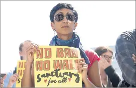  ?? KARL MONDON — STAFF PHOTOGRAPH­ER ?? At City Hall in San Francisco on Tuesday, Sahiba Basrai, of Oakland, holds a sign showing her disapprova­l with the high court’s decision upholding Trump’s travel ban. Joel Rodriguez, 18, below, from San Jose, talks to other protesters in San Jose about the ruling.