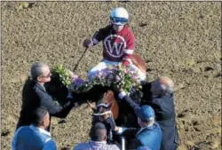  ?? DAVID M. JOHNSON— DJOHNSON@DIGITALFIR­STMEDIA.COM ?? A blanket of roses is draped on Gun Runner, with Florent Geroux up, after winning the 90th edition of the Grade 1Whitney Saturday, Aug. 5, 2017at Saratoga Race Course.
