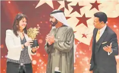  ??  ?? MacDonnell receives the Global Teacher Prize from Sheikh Mohammed bin Rashid alMaktoum (centre), vice-president and Prime Minister of the UAE and Ruler of Dubai, during a ceremony in Dubai. — AFP photo