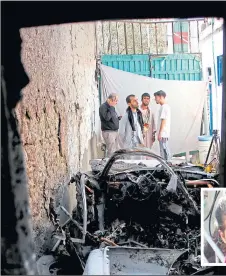  ??  ?? People at the wreckage of the drone attack in Kabul which killed Emal Ahmadi’s daughter Malika, two, below