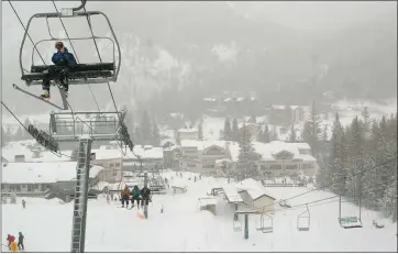  ?? AP FILE PHOTO ?? Skiers ride up Al’s Run lift at the Taos Ski Valley in Taos County, N.M., in 2008. Some resorts are closing enclosed gondolas or aerial trams and others are encouragin­g skiers to ride lifts with only people they know as they adhere to social distancing guidelines. Nearly every resort is promising extra cleanings of public spaces and more hand sanitizer stations and are vowing to follow guidelines from the Centers for Disease Control and Prevention.