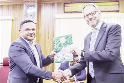  ?? ?? Minister of Natural Resources Vickram Bharrat (at left) hands over an approved Local Content Master Plan to the Area Director of TechnipFMC Nicolas Sicard (Ministry of Natural Resources photo)