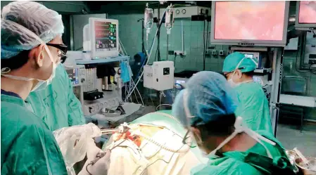  ??  ?? The NHSL team performing the first-ever ‘Natural Orifice Translumin­al Endoscopic Surgery’ (NOTES) on Wednesday