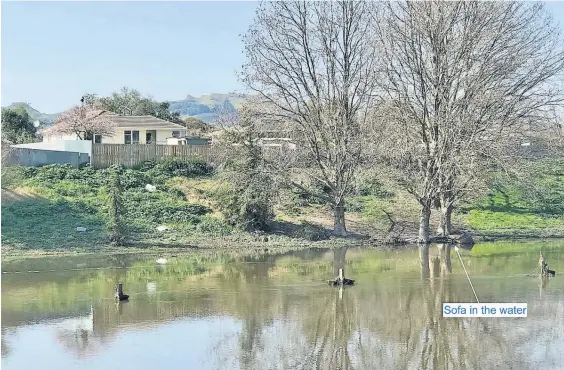  ?? Photo / Supplied ?? Everything from rubbish bags to furniture has been dumped into Karamu stream over the years.