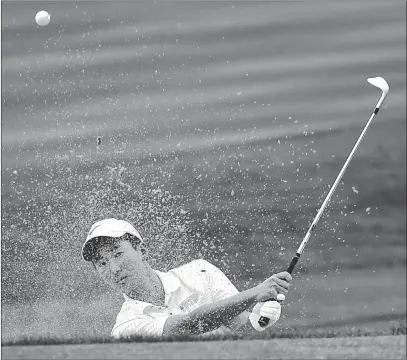  ?? DAVID BECKER/ LAS VEGAS REVIEW-JOURNAL ?? Foothill senior Andrew Chu chips out of a bunker during a practice round at Henderson’s DragonRidg­e Country Club on Monday.