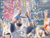  ?? CARMEN MANDATO – GETTY IMAGES ?? Yordan Alvarez of the Astros raises the ALCS Most Valuable Player award after Friday’s Game 6 win over the Red Sox.