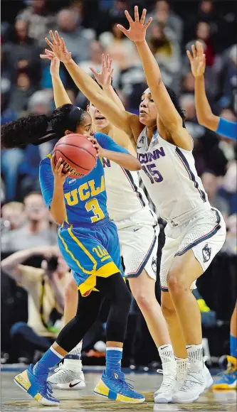  ?? SEAN D. ELLIOT/THE DAY ?? UConn’s Gabby Williams (15) and Kia Nurse apply pressure to UCLA point guard Jordin Canada during the 2017 NCAA Bridgeport Regional. No. 5 UCLA hosts the top-ranked Huskies tonight in Los Angeles.