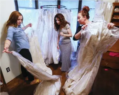  ?? STEVE RUSSELL/TORONTO STAR ?? The Brides’ Project has more than 500 gowns to choose from. The dresses are sold for 50 per cent of their original cost.