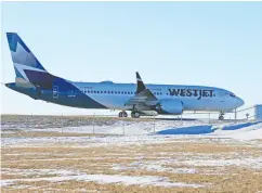  ?? GAVIN YOUNG / POSTMEDIA NEWS ?? A Westjet Boeing 737 Max taxis back to the Westjet hangars on Thursday after a training flight in Calgary.