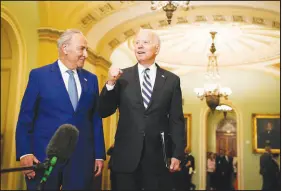  ?? SARAHBETH MANEY / THE NEW YORK TIMES ?? Senate Majority Leader Chuck Schumer, D-N.Y., and President Joe Biden are seen Wednesday at the Capitol. Biden was on Capitol Hill to huddle with Democrats on a newly unveiled $3.5 trillion budget blueprint that if adopted would include universal kindergart­en for all 3- and 4-year-olds, two years of free community college, clean energy requiremen­ts for utilities, expanded Medicare benefits and the extension of green cards to more immigrants in the country illegally.